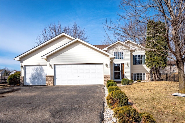 1874 Niagara St, Waconia, MN 55387 - view of front of home featuring asphalt driveway, brick siding, a garage, and a front lawn