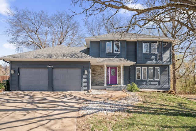 traditional home with an attached garage, a shingled roof, and concrete driveway