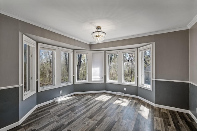 unfurnished dining area with crown molding, visible vents, baseboards, dark wood-style floors, and a notable chandelier