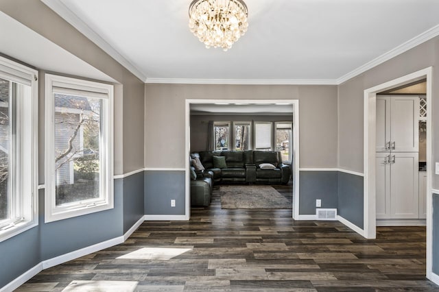 interior space featuring baseboards, plenty of natural light, dark wood finished floors, and visible vents