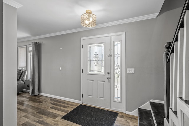 entrance foyer with crown molding, baseboards, an inviting chandelier, and wood finished floors