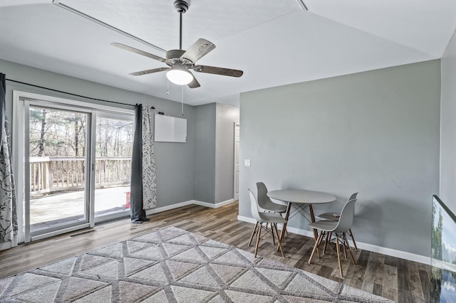 dining area with baseboards, a ceiling fan, and wood finished floors