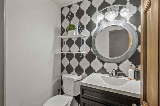 bathroom featuring vanity and toilet