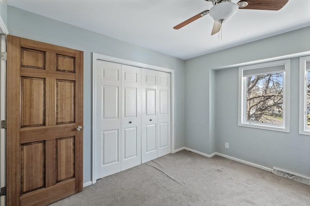 unfurnished bedroom with ceiling fan, visible vents, baseboards, a closet, and carpet