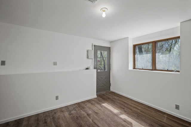 empty room featuring baseboards and wood finished floors