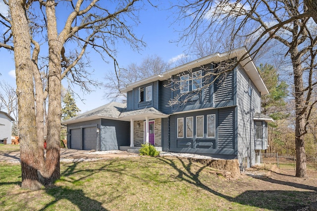 traditional-style home featuring a garage, fence, driveway, and a front yard
