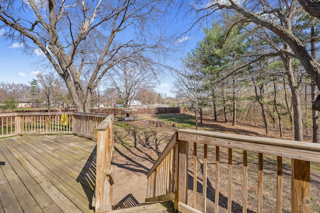 wooden deck with a fenced backyard