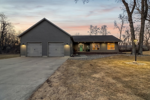 view of front of property featuring concrete driveway and a garage
