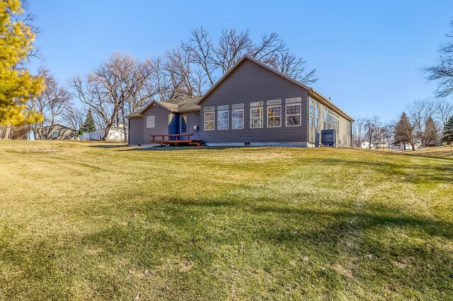 back of property featuring a yard
