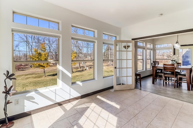 doorway to outside with baseboards