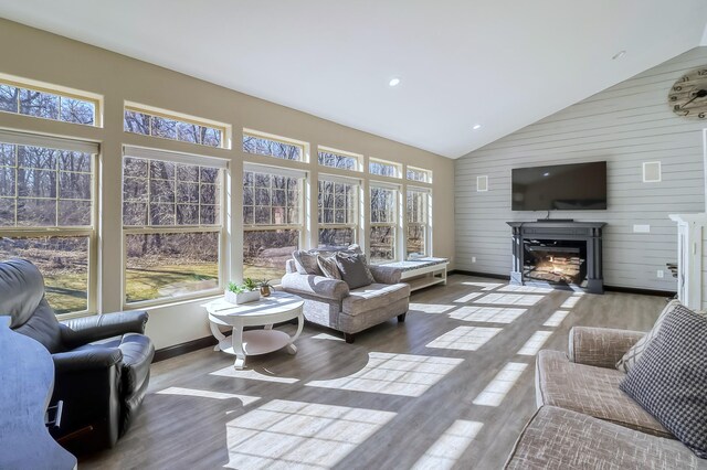 sunroom featuring recessed lighting, wood walls, high vaulted ceiling, and wood finished floors