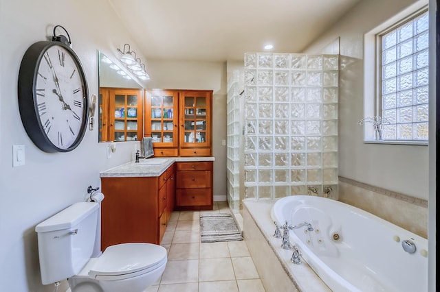 full bathroom featuring toilet, a jetted tub, tile patterned floors, walk in shower, and vanity