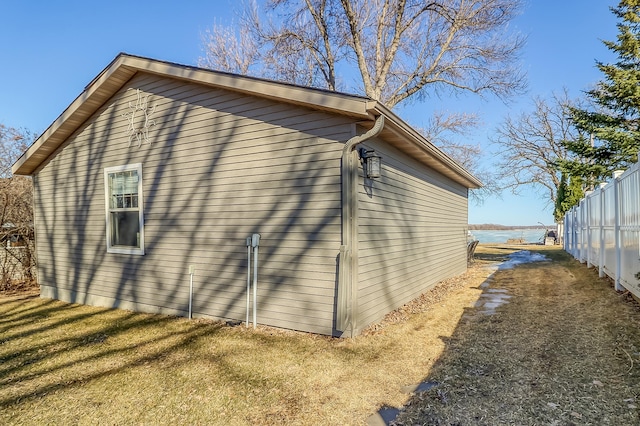 view of side of home featuring fence