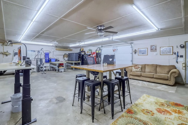 interior space featuring unfinished concrete flooring and a ceiling fan