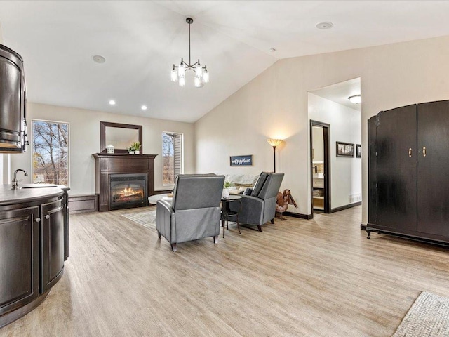 46747 Poss Beach Rd, Pelican Rapids, MN 56572 - living area with lofted ceiling, healthy amount of natural light, light wood-type flooring, a glass covered fireplace, and recessed lighting