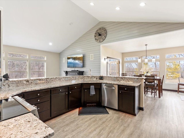 46747 Poss Beach Rd, Pelican Rapids, MN 56572 - kitchen featuring dishwasher, wood walls, high vaulted ceiling, dark brown cabinets, and light stone countertops