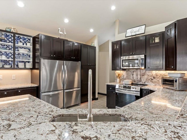 46747 Poss Beach Rd, Pelican Rapids, MN 56572 - kitchen with stainless steel appliances, light stone counters, backsplash, light wood-style flooring, and recessed lighting