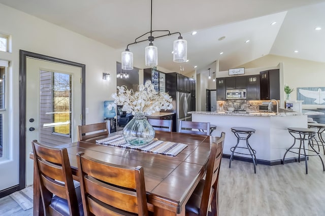 46747 Poss Beach Rd, Pelican Rapids, MN 56572 - dining area featuring lofted ceiling and light wood-style floors