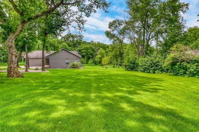 46747 Poss Beach Rd, Pelican Rapids, MN 56572 - view of grassy yard with a garage