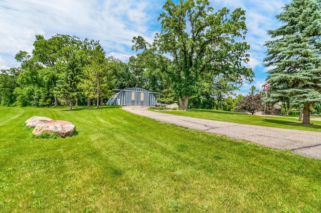 46747 Poss Beach Rd, Pelican Rapids, MN 56572 - view of green lawn with an outdoor structure and view of wooded area