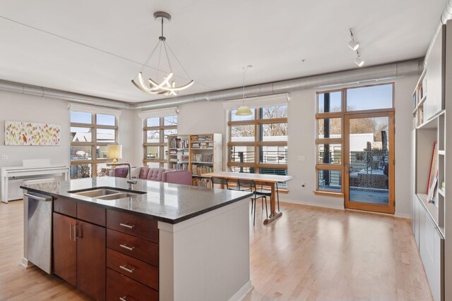 2840 Bryant Ave S Unit E302, Minneapolis, MN 55408 - kitchen featuring an island with sink, light wood-style flooring, plenty of natural light, and a chandelier