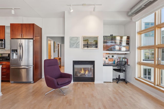 2840 Bryant Ave S Unit E302, Minneapolis, MN 55408 - living area with track lighting, a glass covered fireplace, and light wood finished floors