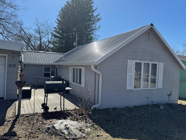 view of side of home with metal roof