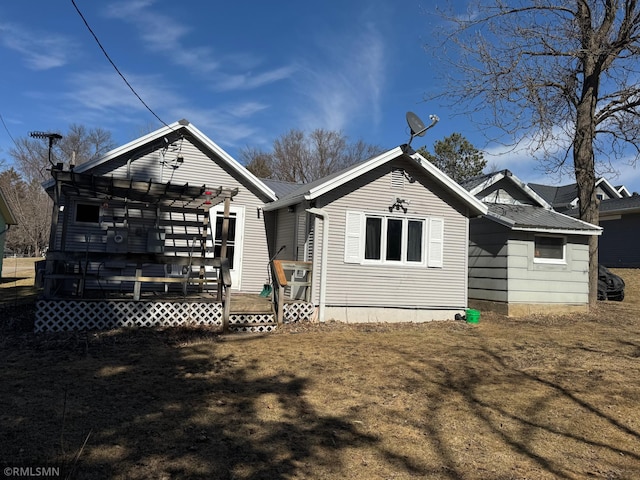 back of property with a wooden deck