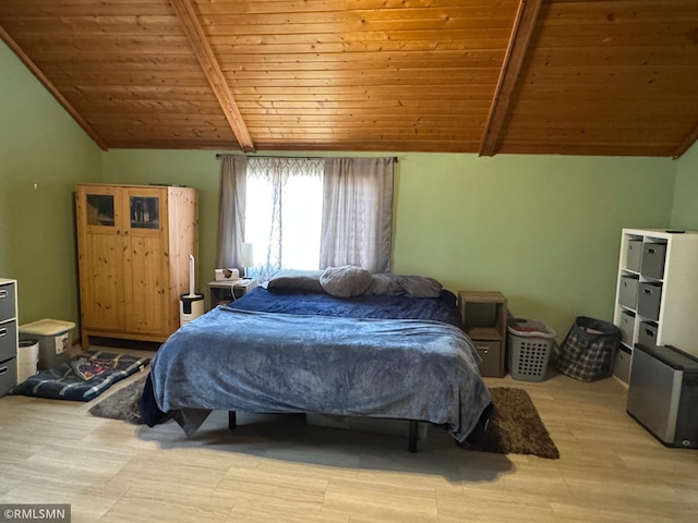 bedroom featuring lofted ceiling with beams, light wood-style flooring, and wooden ceiling