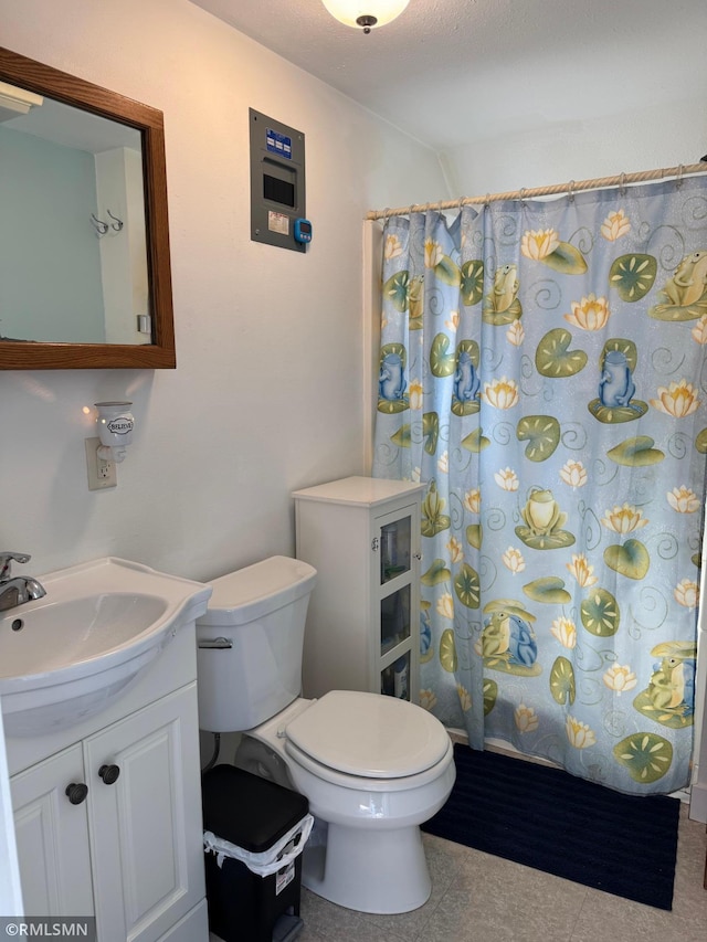 full bath with vanity, toilet, a shower with curtain, and tile patterned flooring