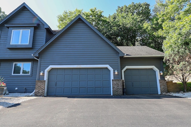 13720 Georgia Dr, Apple Valley, MN 55124 - view of front facade with brick siding, asphalt driveway, and a garage