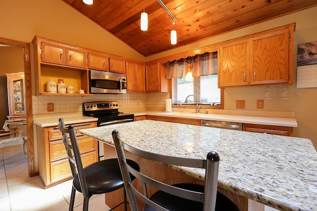 13720 Georgia Dr, Apple Valley, MN 55124 - kitchen with stainless steel appliances, lofted ceiling, wood ceiling, decorative backsplash, and a kitchen breakfast bar