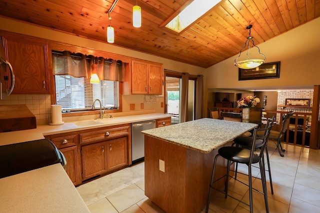 13720 Georgia Dr, Apple Valley, MN 55124 - kitchen with dishwasher, brown cabinetry, lofted ceiling, a center island, and a skylight