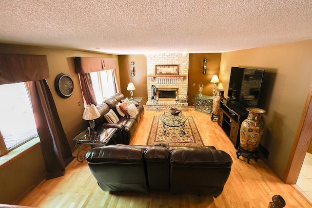13720 Georgia Dr, Apple Valley, MN 55124 - living room with a brick fireplace, wood finished floors, and a textured ceiling