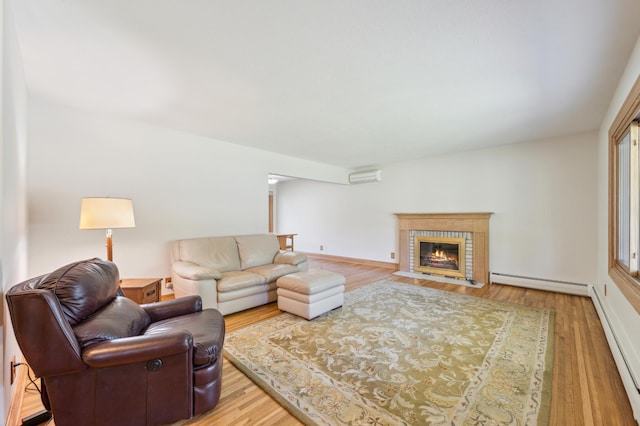 11413 Christansen Ct, Burnsville, MN 55337 - living area featuring a baseboard radiator, wood finished floors, and a fireplace