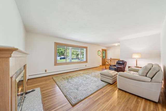 11413 Christansen Ct, Burnsville, MN 55337 - living area with a baseboard heating unit, a fireplace with flush hearth, and wood finished floors