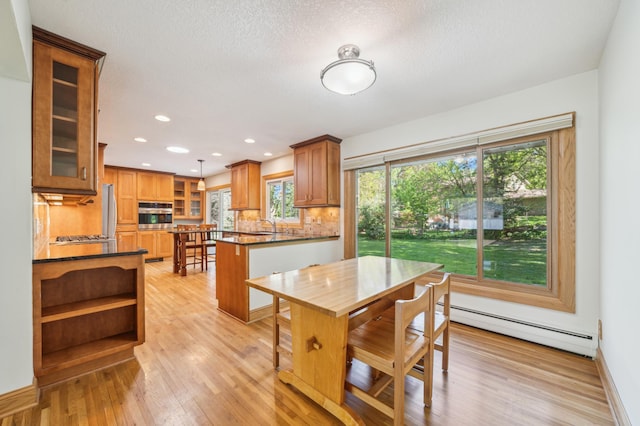 11413 Christansen Ct, Burnsville, MN 55337 - dining space with a baseboard radiator, healthy amount of natural light, light wood-style floors, recessed lighting, and a textured ceiling