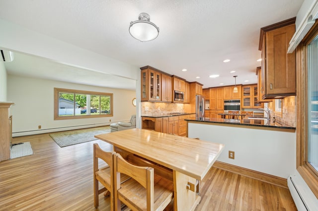 11413 Christansen Ct, Burnsville, MN 55337 - dining room featuring a baseboard heating unit, a baseboard radiator, light wood-style flooring, baseboards, and recessed lighting