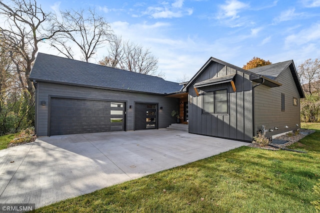 view of front of house featuring a front lawn, board and batten siding, and concrete driveway