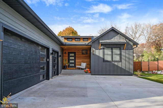 view of front of property with board and batten siding and fence