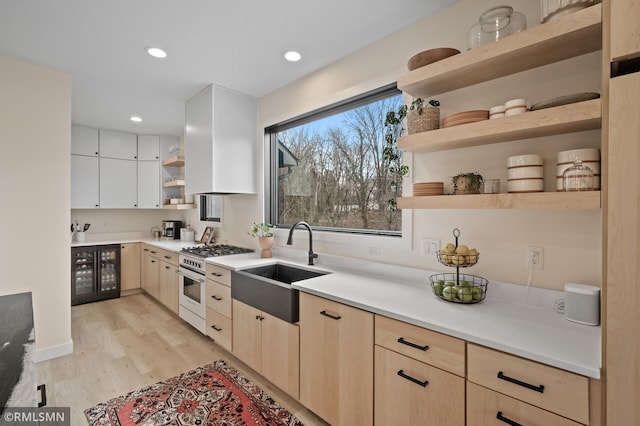 kitchen featuring open shelves, stainless steel range, and light brown cabinets