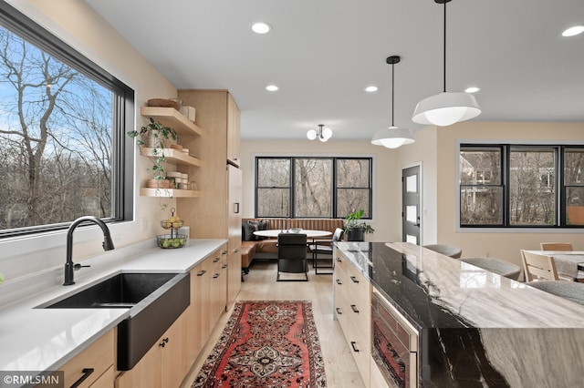 kitchen with recessed lighting, a sink, light wood-style flooring, and light brown cabinetry