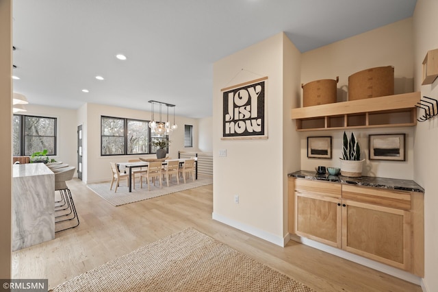 corridor with recessed lighting, baseboards, and light wood-type flooring