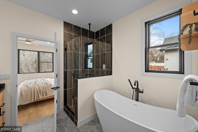 full bath featuring a freestanding bath, plenty of natural light, a stall shower, and ensuite bath