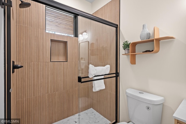 full bath featuring a shower stall and toilet
