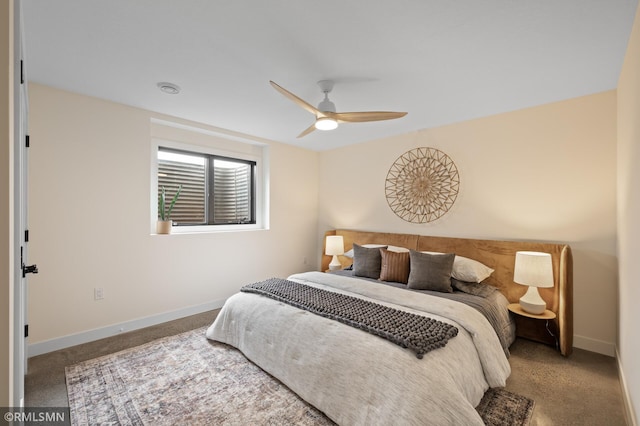 carpeted bedroom featuring baseboards and a ceiling fan