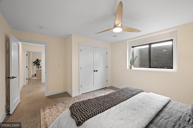 bedroom featuring baseboards, ceiling fan, and a closet