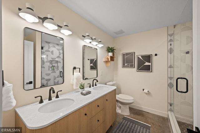 full bath with baseboards, a sink, toilet, and a shower stall