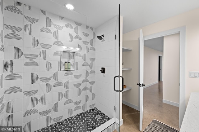 full bathroom featuring baseboards, finished concrete floors, and a stall shower
