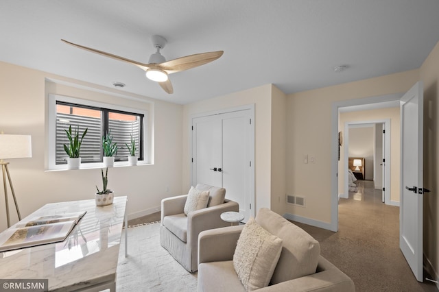 home office with baseboards, a ceiling fan, and visible vents